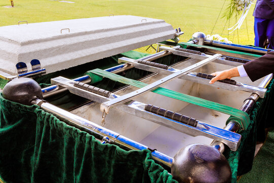 Family friends gather to bid final farewell at graveside burial ceremony during funeral ceremony