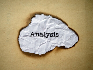 A close-up image of the word Analysis 
 printed on a burnt paper