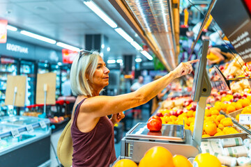 Woman using digital scale in grocery store