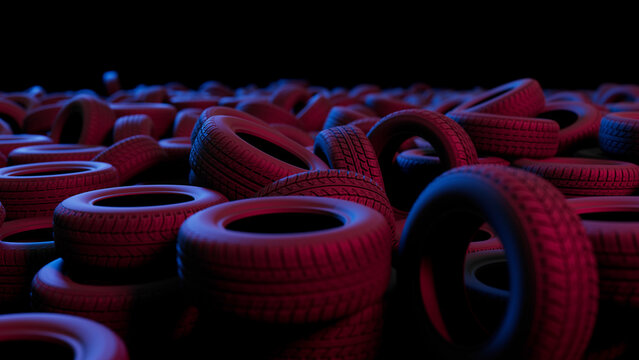 Many car tires are piled up, creating a mountain like shape, illuminated by vibrant red and blue lights, adding a dramatic and artistic touch to the scene