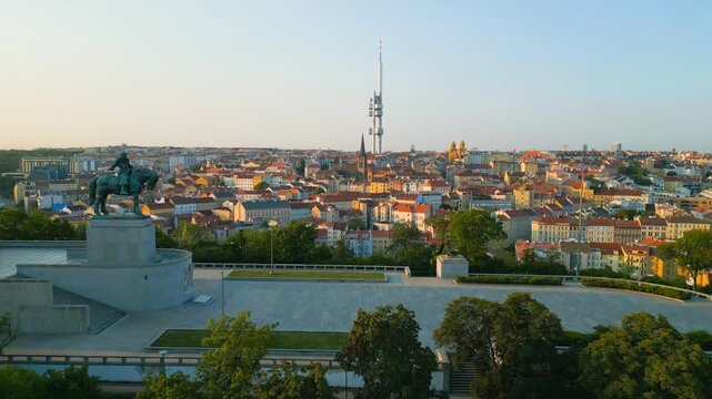 Discover the Jan Zizka statue overlooking the city from Vitkov Hill, with the iconic Zizkov Tower in the background. The vibrant views of Prague showcase the city's beauty and history.