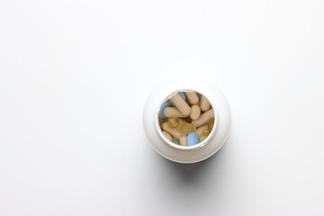 Vitamins pills bottle top view in a white background