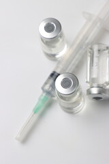Vitamins pills and injectable in a white background