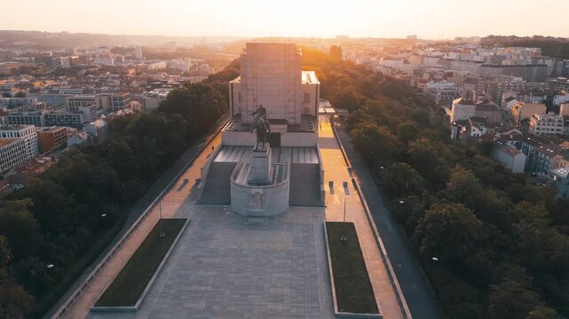 Witness the majestic National Monument at Vitkov Hill bathed in sunlight during a serene morning. This iconic memorial honors Jan Zizka and offers stunning views of Prague.