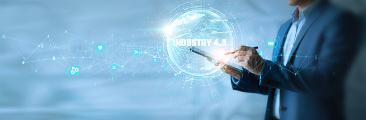 Businessman using tab Industry 4.0 icon with global network. Smart factories, automation systems, AI integration, IoT connectivity, machine learning, digital transformation.