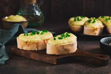 Sandwiches with zucchini and onion spread on ciabatta on a board on a table