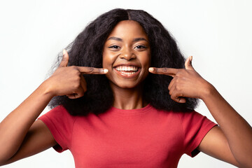 Dental Health. Beautiful Young African American Woman Pointing At Her Smile With Two Fingers,...