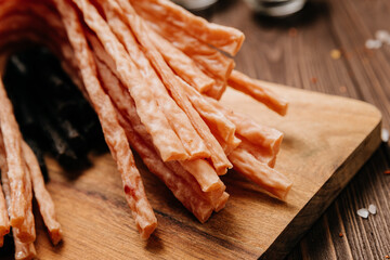 Variety of black and light meat sticks on board with herbs and spices, ideal for culinary display