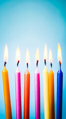 Colorful birthday candles with glowing flames, creating a festive and celebratory atmosphere.
