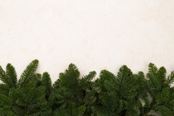 Christmas tree branches on concrete background, top view
