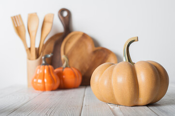 Autumn Kitchen Decor with Wooden Utensils and Ceramic Pumpkins
