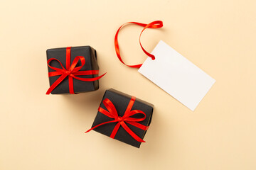 Black gift boxes on color background, top view. Black Friday concept
