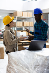 Multiethnic factory staff oversees shipment preparation and inventory management. Handling...