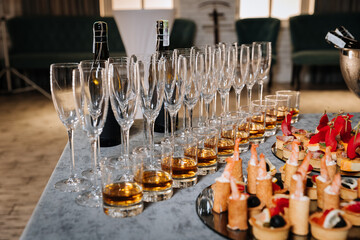 Elegant catering setup with gourmet canapes and whiskey in glasses for a corporate event