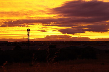 Fototapeta premium Telecommunication tower at sunset with dramatic sky