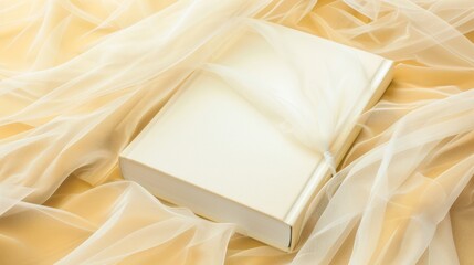 Open Blank Notebook Lying on Soft Cream Satin Fabric with Sheer Overlay for Creative or Stationery Use