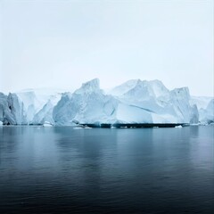 A polar seascape with large ice floes standing tall on the horizon, reflecting soft light on the calm water surface below.