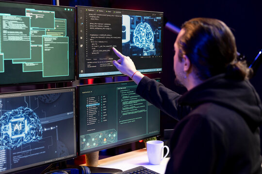 Hacker at home neural network app on PC to breach company security and open locked databases. Rogue software developer doing cyber attacks, operating hacking platforms with deep learning technology