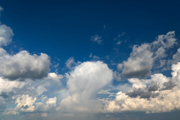 Blue sky with white summer rain clouds. Colorful summer landscape