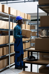 African american staff handling cargo for orders shipment in the storage room, delivery and storage processes occur in a well organized warehouse unit. Import export parcels dispatch.