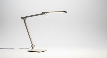 Modern LED Desk Lamp Illuminating a White Background.