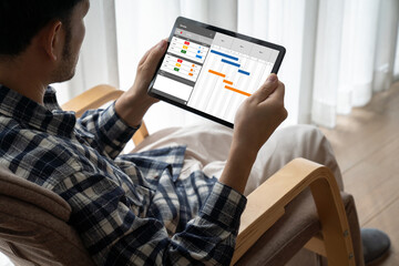 Project planning software for modish business project management on the computer screen showing timeline chart of the team project
