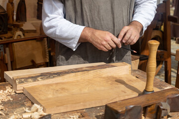 Carpenter sharpening pencil getting ready to work wood plank