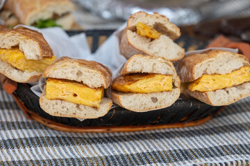 Spanish omelette bocadillos resting in a basket on a tablecloth