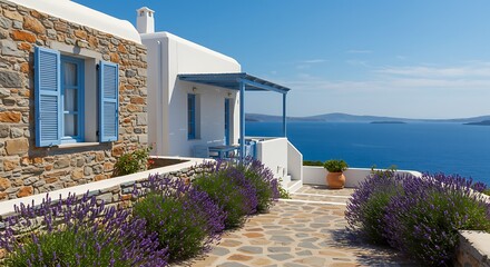 Fototapeta premium Exterior of a classic house located in a Greek island villa, featuring sleek stone finishes with flowering lavender bushes. Elegant and Timeless Style