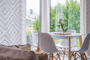 Scandinavian interior featuring minimalistic dining area with bright airy atmosphere, functional furniture, and cosy textures, ideal for modern living and relaxation with copy space