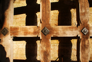 Beautiful historical wooden gate in ancient fortress, lattice, doors.