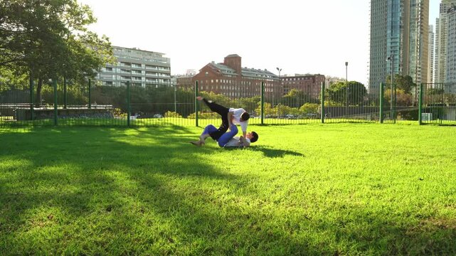Young athletes practicing  Jiu Jitsu outdoors.