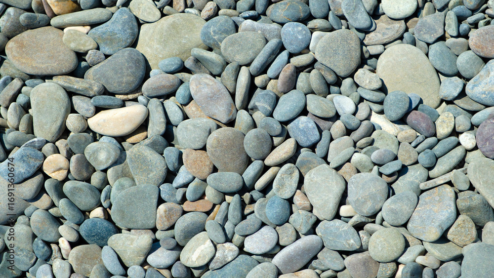Poster pebbles stones on seashore as texture background for design of web banner template page. many stones