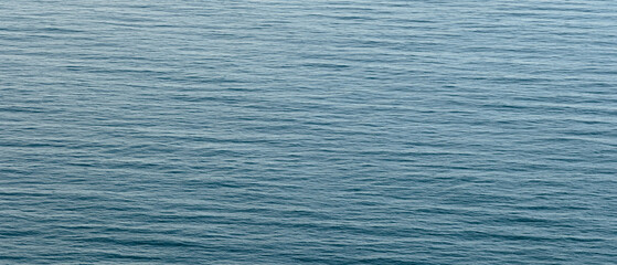 Fototapeta premium Blue calm sea as texture background for web banner template page design.