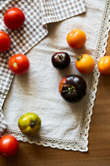 Multicolored tomatoes on the table top view indoors in autumn