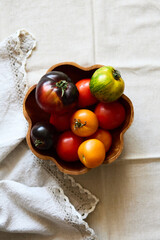 Multicolored tomatoes on the table top view indoors in autumn