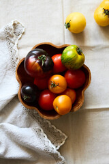 Multicolored tomatoes on the table top view indoors in autumn