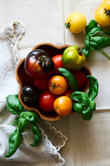 Multicolored tomatoes on the table top view indoors in autumn
