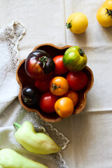 Multicolored tomatoes on the table top view indoors in autumn