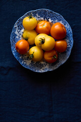Multicolored tomatoes on the table top view indoors in autumn