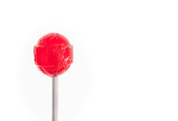 A red candy sucker on a white background, copy space on right