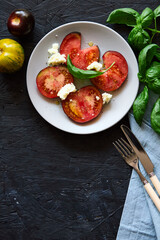 Red farm tomatoes on a plate top view