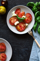 Red farm tomatoes on a plate top view