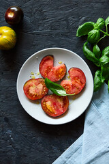 Red farm tomatoes on a plate top view