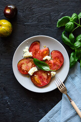 Red farm tomatoes on a plate top view