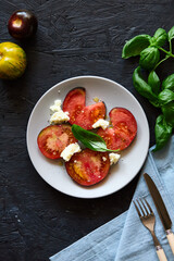 Red farm tomatoes on a plate top view