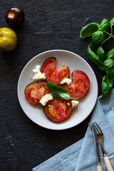 Red farm tomatoes on a plate top view