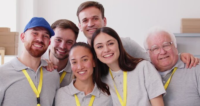 Diverse caring volunteer team, group smiling looking at camera, people working in charitable foundation, for needy. Charity, separating donations stuff, basic care need, free help for people in need