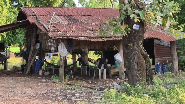 Rural Wooden House with Rusty Roof in Countryside from Laos Village