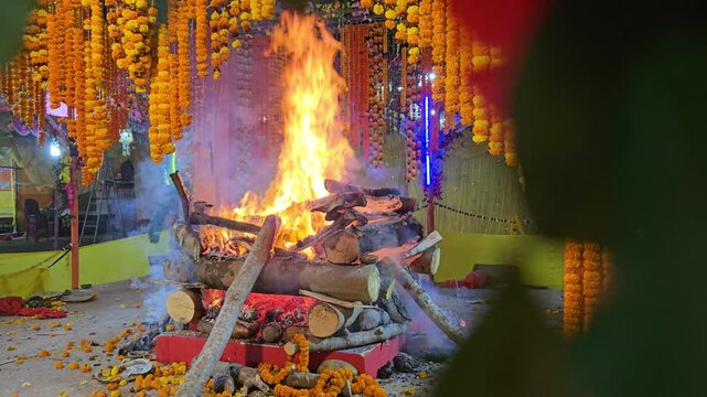 Sacred fire ritual Yajna or Yagna, Hindu puja ceremony with havan, Spiritual worship with holy fire, Traditional Indian religious ritual stock video footage.